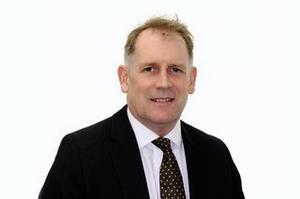 Profile head and shoulders image of Jim Morris in a suit and tie